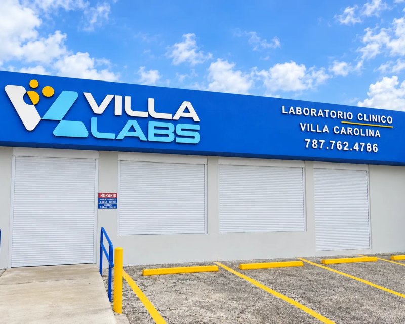 Blue facade sign for Villa Labs clinical laboratory in Villa Carolina