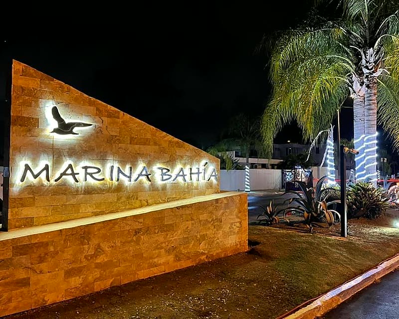 Illuminated dimensional letters of the Marina Bahía sign on an exterior wall