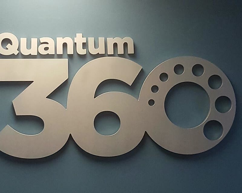 Dimensional letters of the Quantum 360 logo mounted on a wall