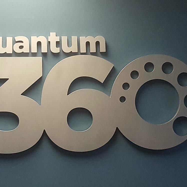 Dimensional letters of the Quantum 360 logo mounted on a wall