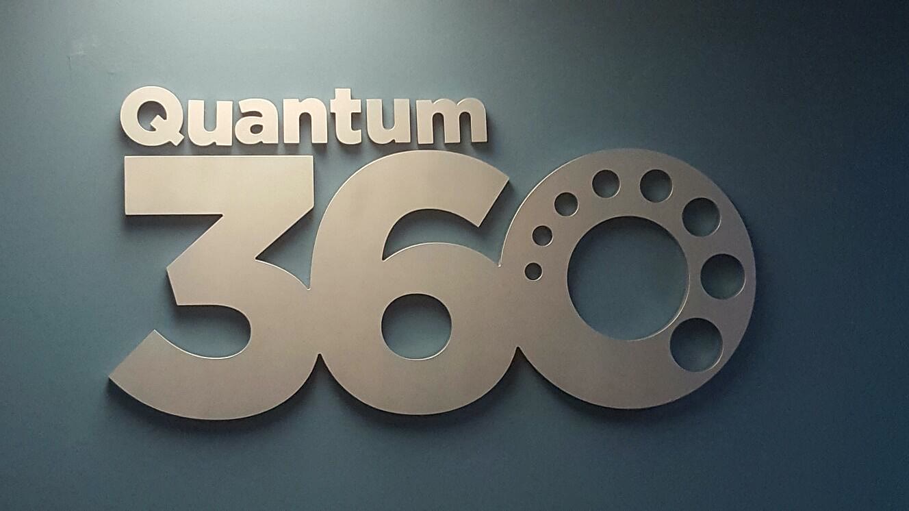 Dimensional letters of the Quantum 360 logo mounted on a wall