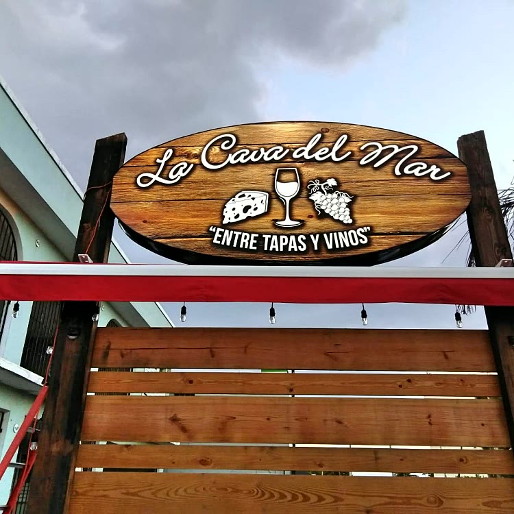 Wooden exterior sign for La Casa del Mar restaurant
