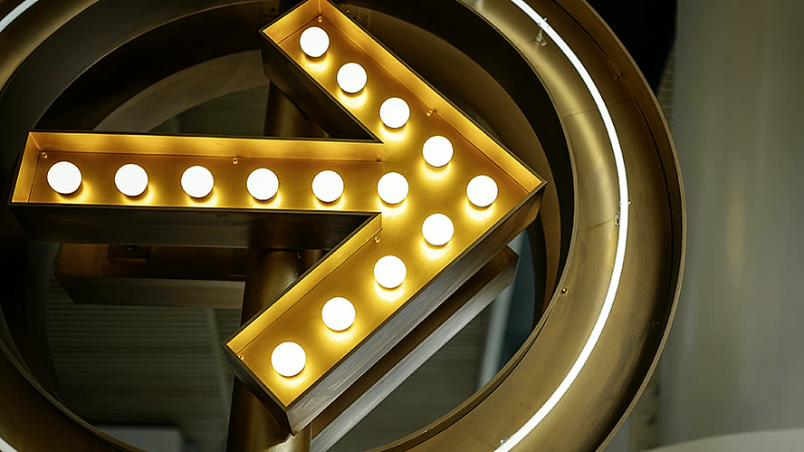 Illuminated sign switched on, with the bulbs lit inside the letter.