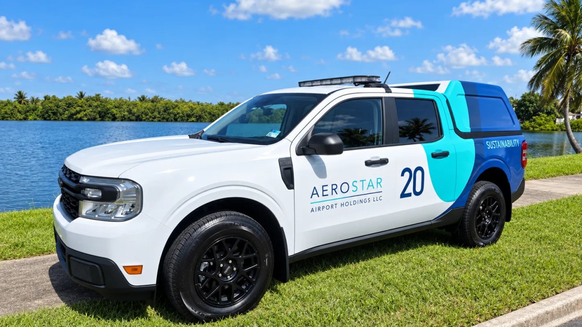White Aerostar Airport Holdings pickup with blue graphics and unit number
